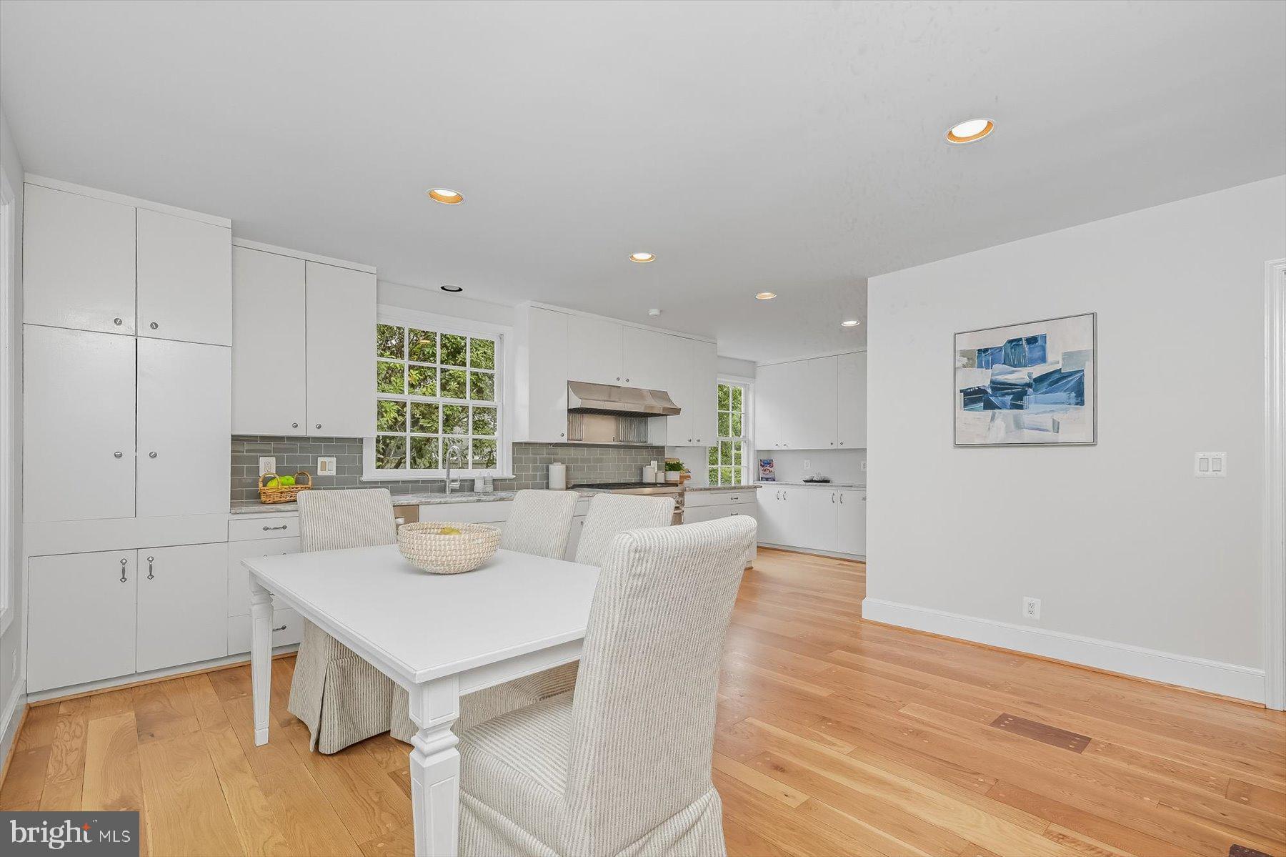 6302 Broad Branch Road Chevy Chase, MD 20815 - Photo 15 of 55 a living room with stainless steel appliances furniture a large window and a wooden floor
