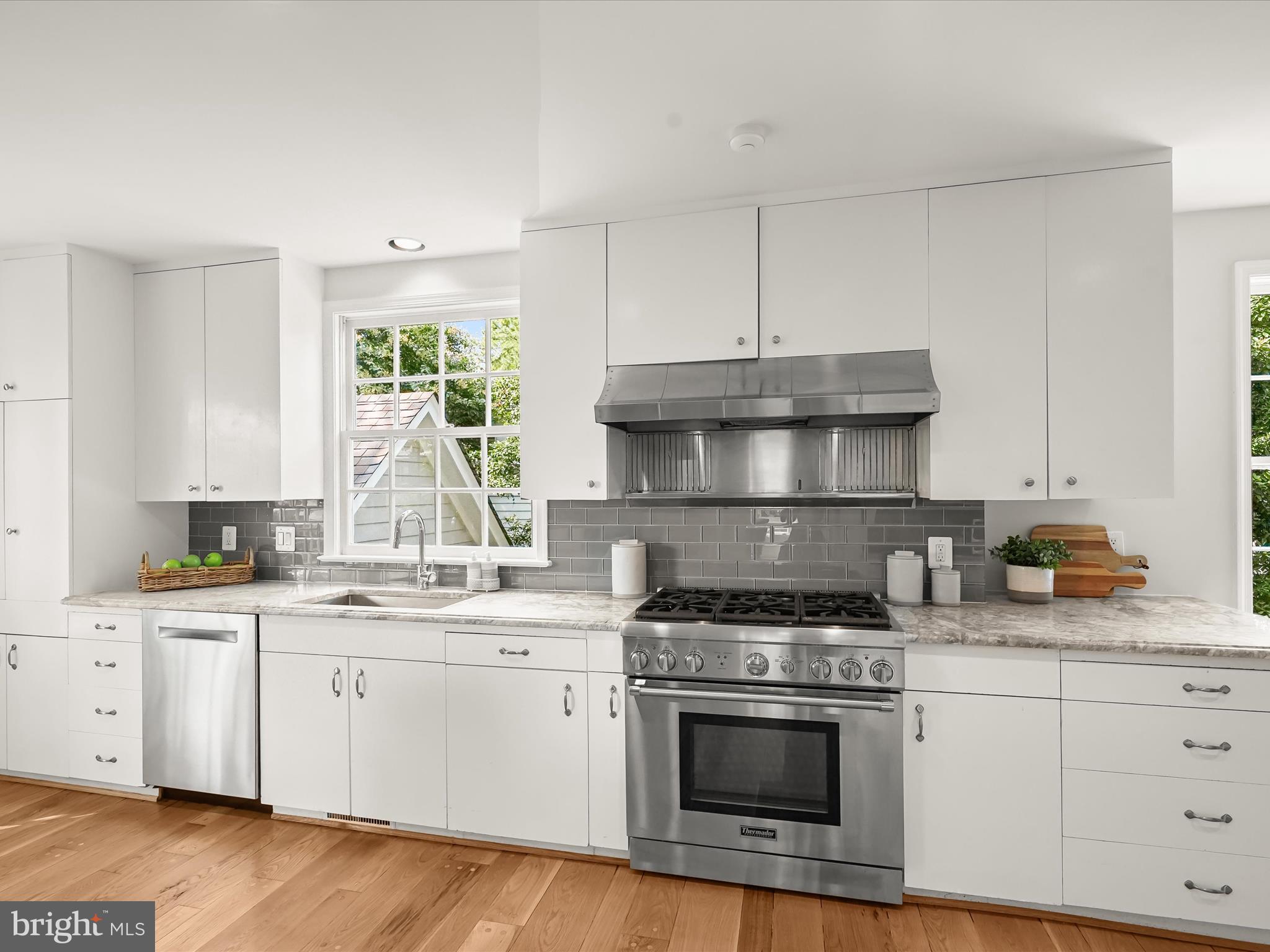 6302 Broad Branch Road Chevy Chase, MD 20815 - Photo 16 of 55 a kitchen with stainless steel appliances granite countertop a sink stove and cabinets