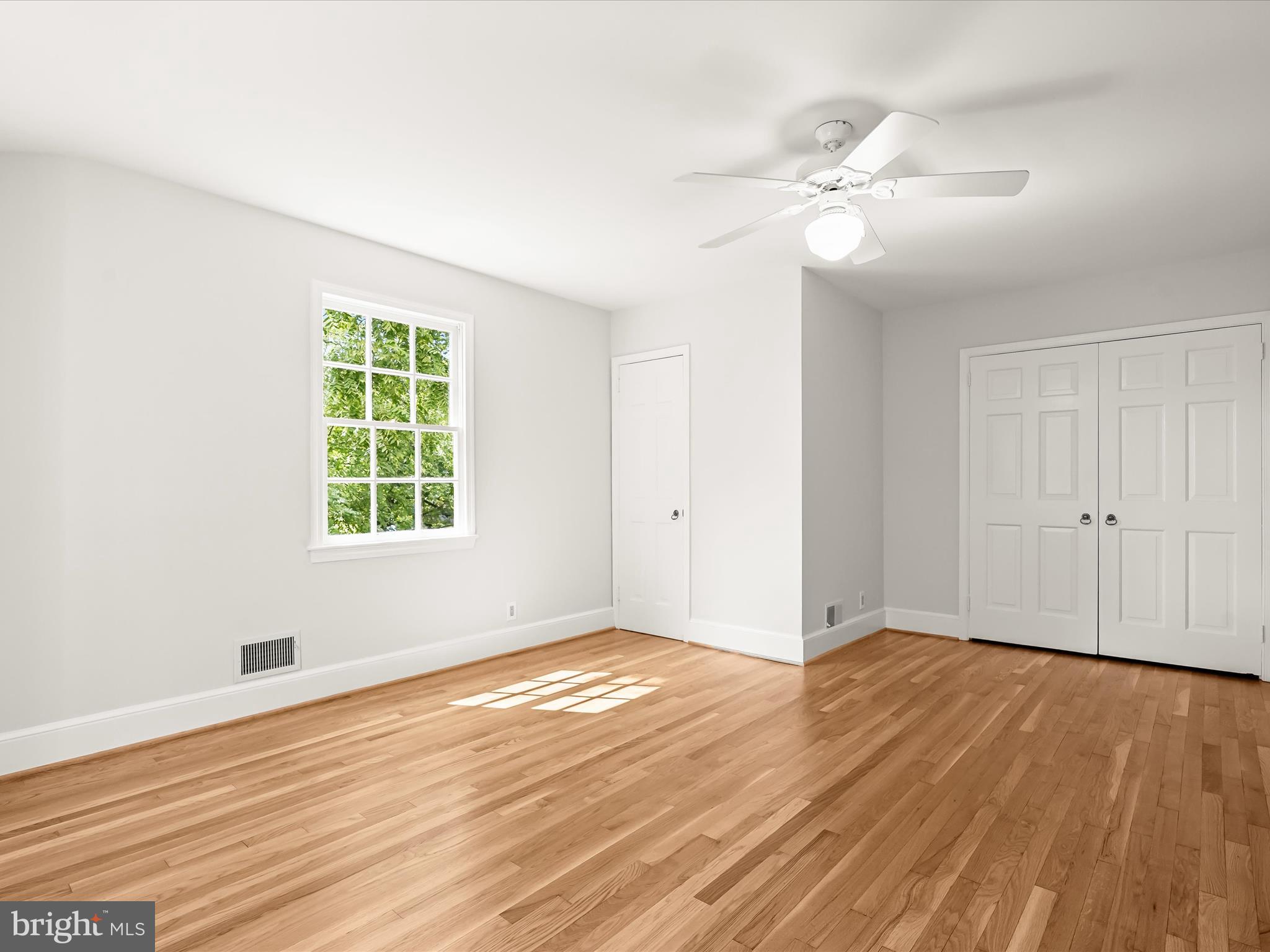 6302 Broad Branch Road Chevy Chase, MD 20815 - Photo 37 of 55 a view of an empty room with wooden floor and a window