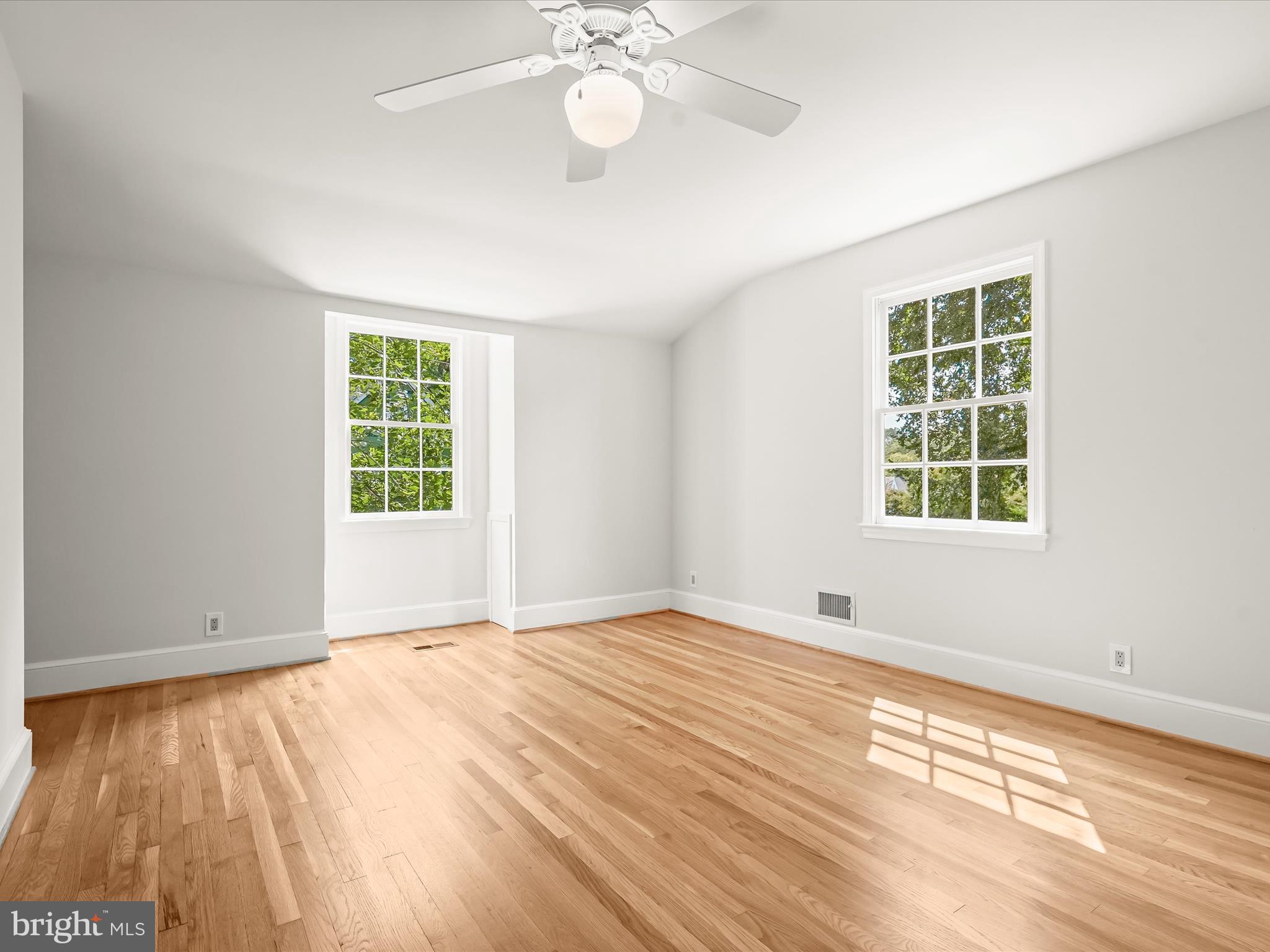 6302 Broad Branch Road Chevy Chase, MD 20815 - Photo 38 of 55 a view of an empty room with a window and wooden floor