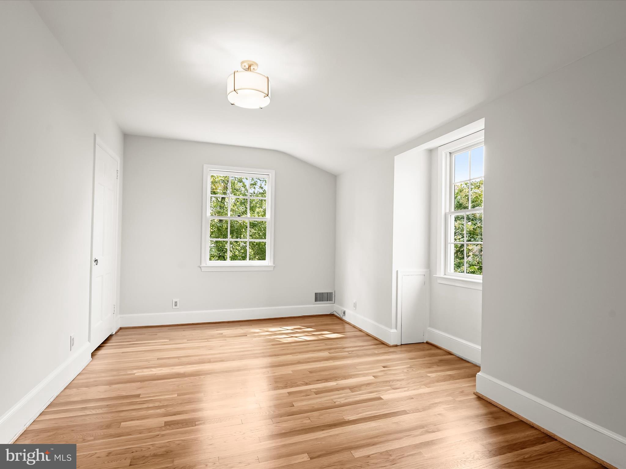 6302 Broad Branch Road Chevy Chase, MD 20815 - Photo 40 of 55 wooden floor in an empty room with a window