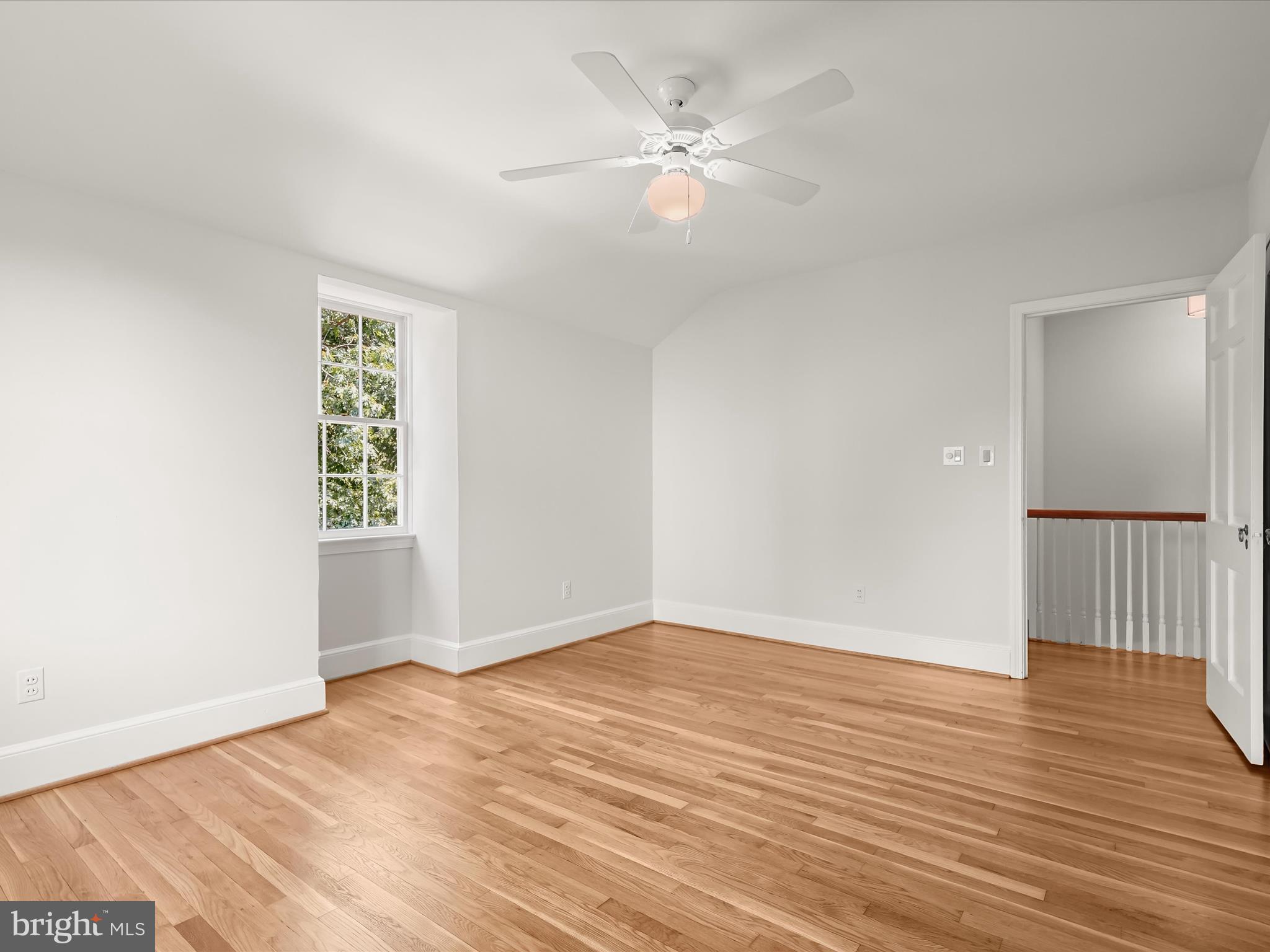 6302 Broad Branch Road Chevy Chase, MD 20815 - Photo 41 of 55 an empty room with wooden floor and window