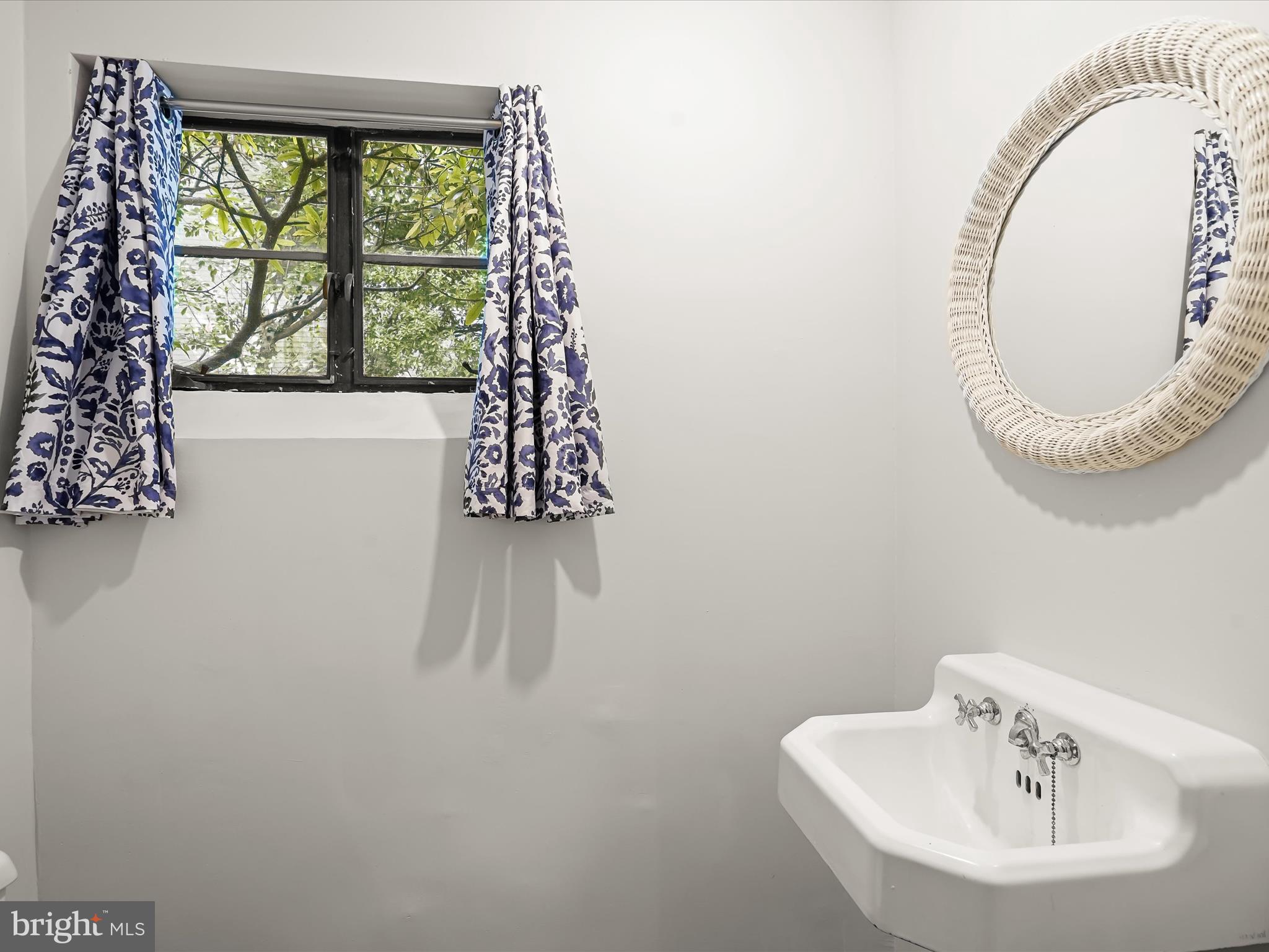 6302 Broad Branch Road Chevy Chase, MD 20815 - Photo 50 of 55 a bathroom with a sink and a mirror