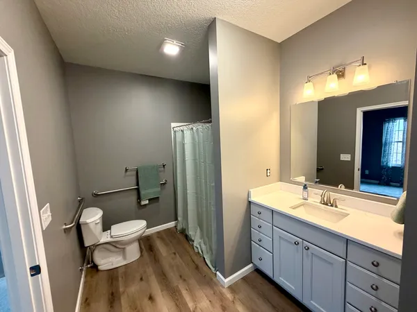 a bathroom with a double vanity sink toilet and shower