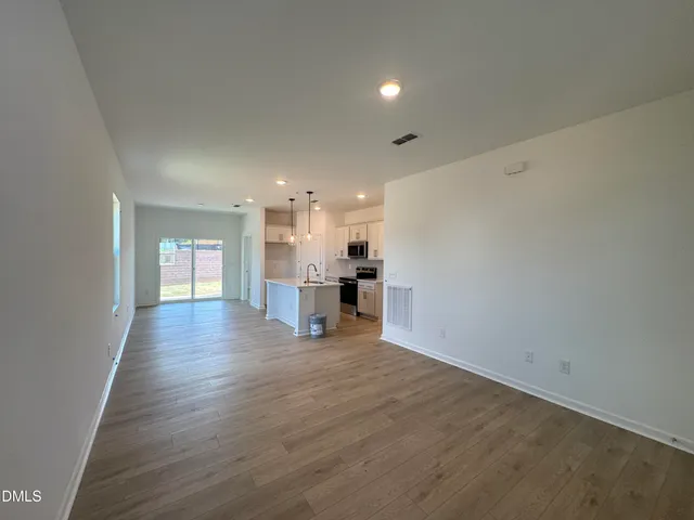 a view of a kitchen with a sink and a refrigerator