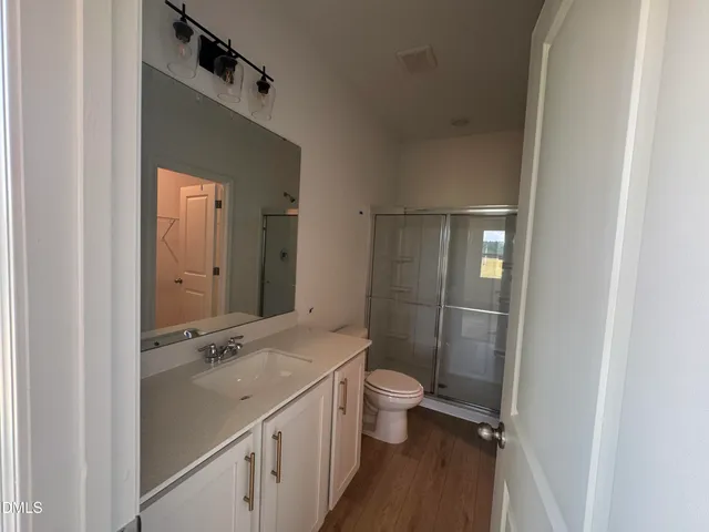 a bathroom with a sink and mirror with toilet