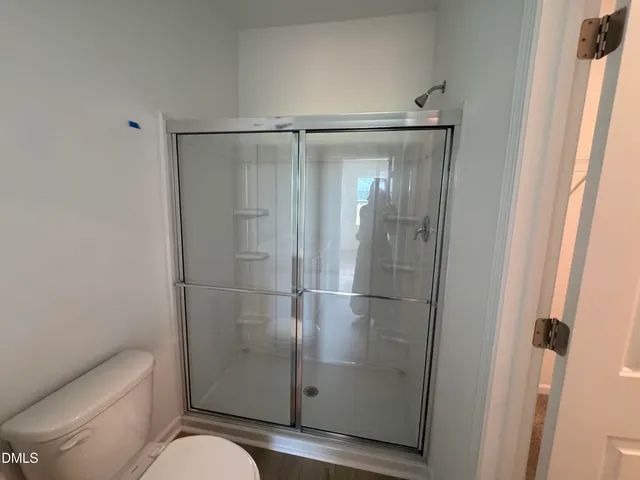 a bathroom with a shower and toilet