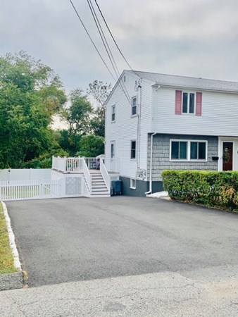 6 Saugus Avenue, Unit A Saugus, MA 01906 - Photo 2 of 26 a view of a white house with a large space and a garage