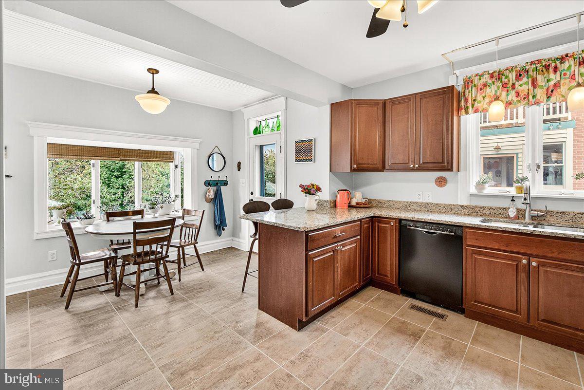 144 South Main Street Boonsboro, MD 21713 - Photo 13 of 48 a kitchen with stainless steel appliances granite countertop a stove top oven a sink dishwasher a dining table and chairs with wooden floor