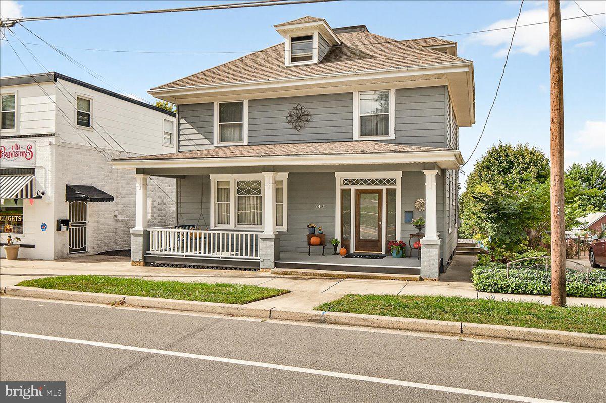 144 South Main Street Boonsboro, MD 21713 - Photo 2 of 48 a front view of a house with a garden and plants
