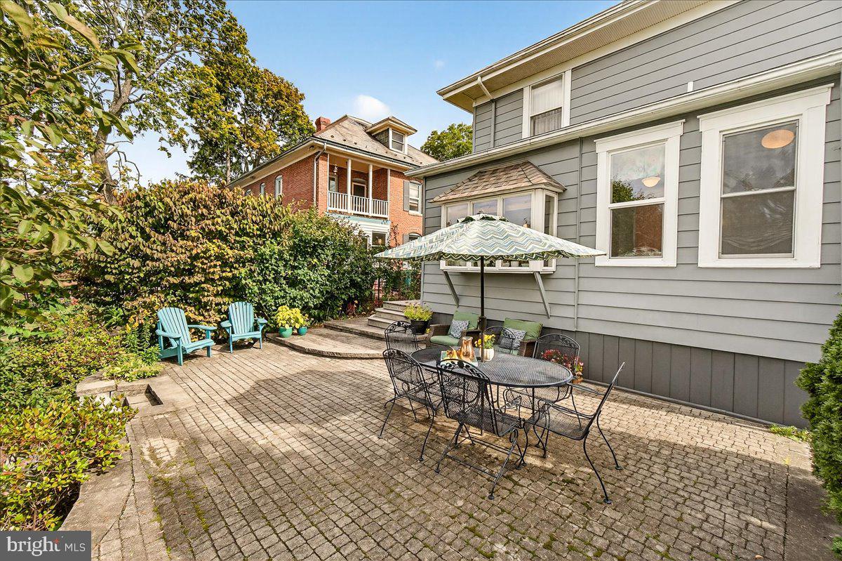 144 South Main Street Boonsboro, MD 21713 - Photo 39 of 48 a patio with a table and chairs under an umbrella
