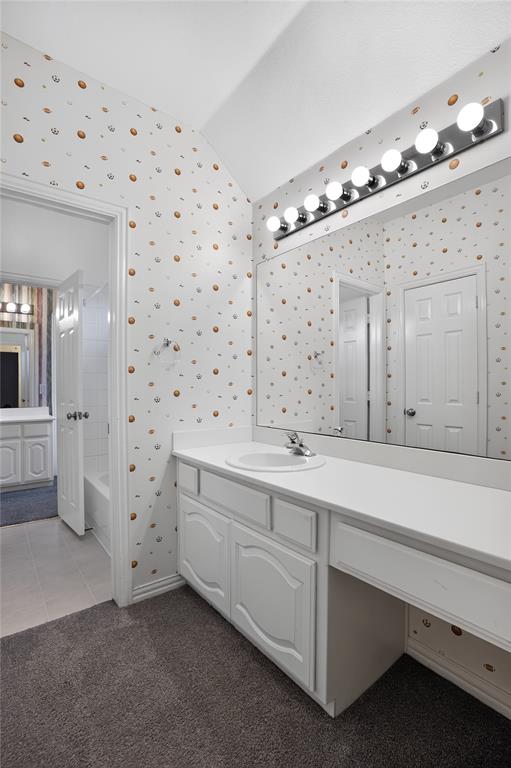 111 Ripplewood Coppell, TX 75019 - Photo 26 of 34 Bathroom featuring a single vanity with an integrated sink, white cabinetry, a built-in makeup vanity, and a wall-mounted light bar with eight bulbs