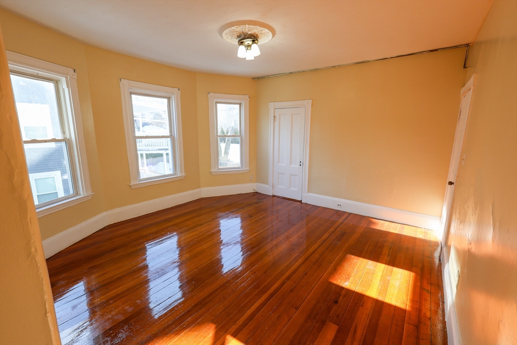 35 Clarkson Street, Unit 2 Boston, MA 02125 - Photo 4 of 9 a view of an empty room with wooden floor and a window
