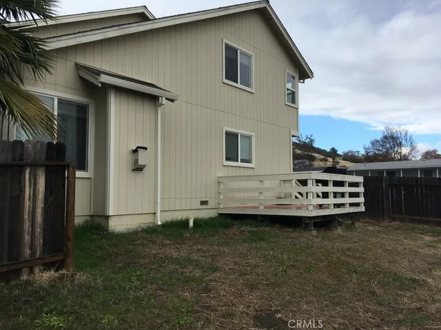 a view of backyard with wooden fence