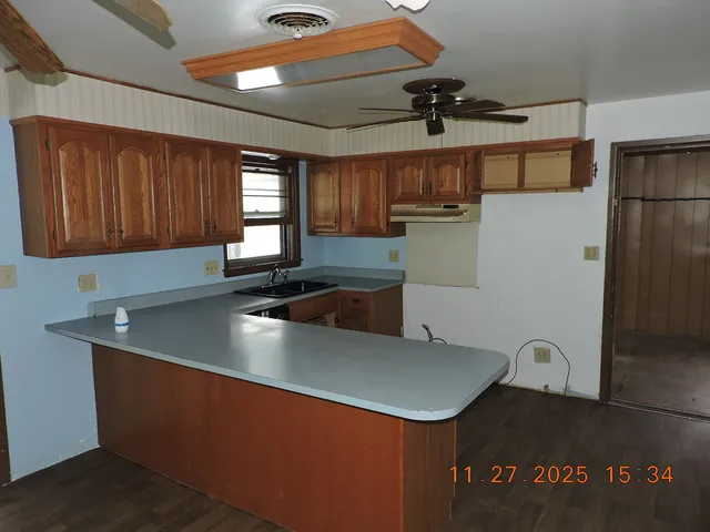 a kitchen with stainless steel appliances granite countertop a sink a stove and a refrigerator