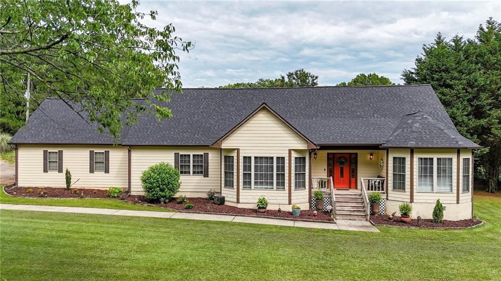 404 Carruth Road Winder, GA 30680 - Photo 1 of 1 a front view of a house with a yard table and chairs