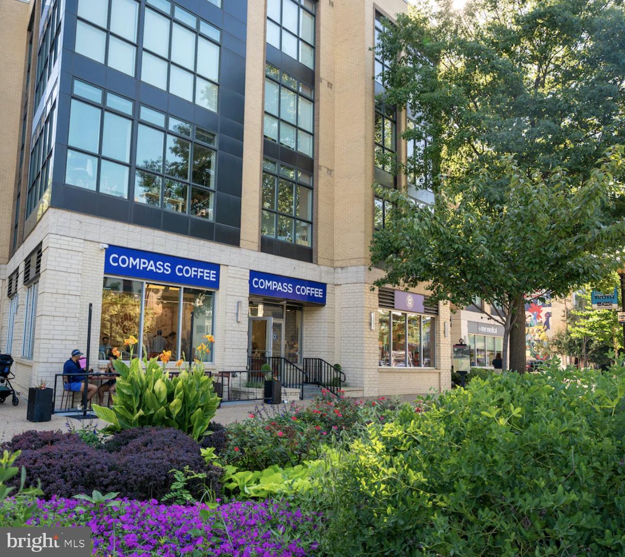 2707 Adams Mill Road Northwest, Unit 303 Washington, DC 20009 - Photo 26 of 27 a front view of a building with garden
