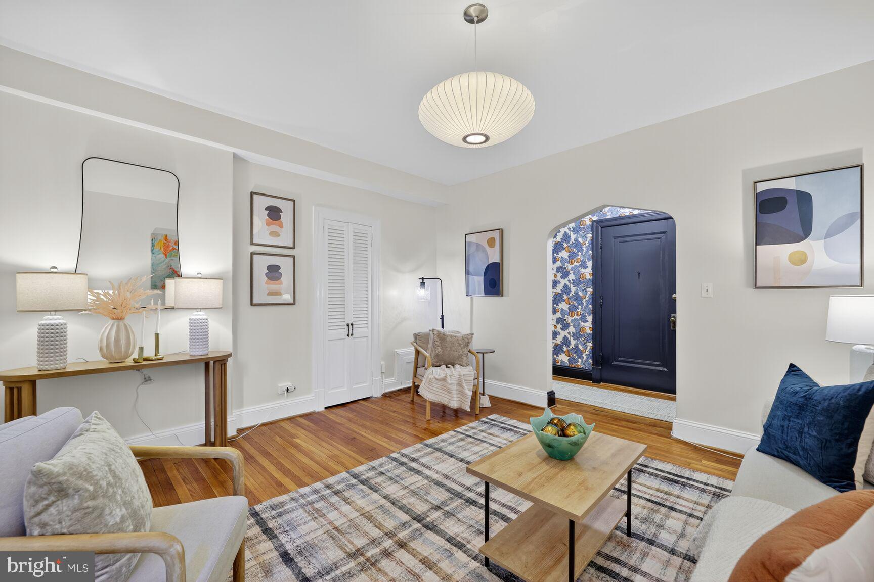 2707 Adams Mill Road Northwest, Unit 303 Washington, DC 20009 - Photo 10 of 27 a living room with furniture and wooden floor
