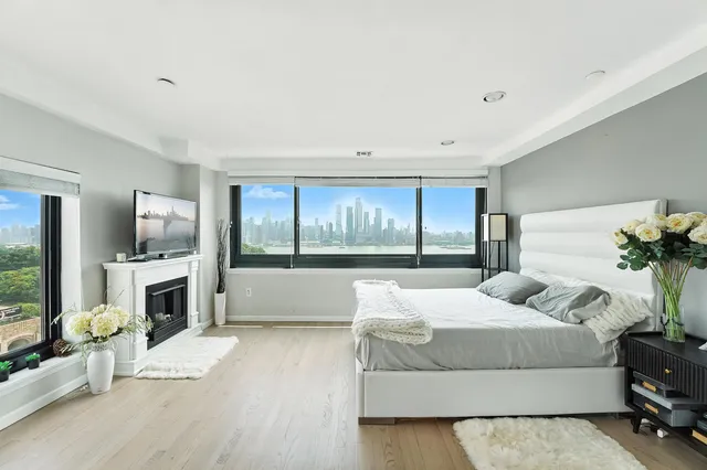 a bedroom with a large bed and a flat screen tv