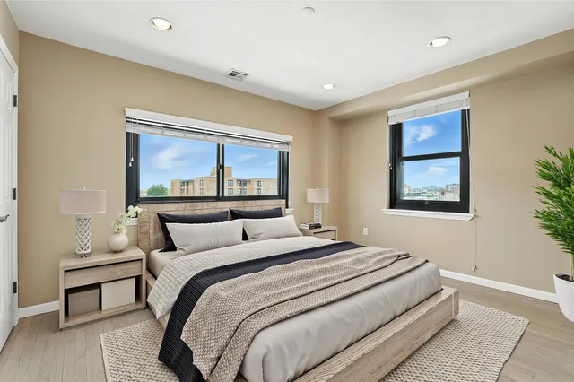 a bedroom with a bed and a painting on the wall