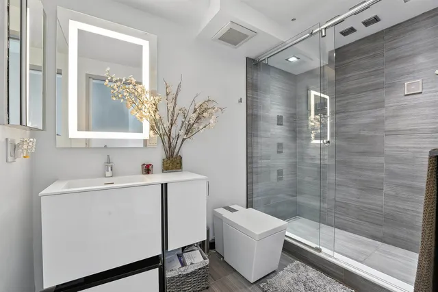 a bathroom with a sink toilet and shower