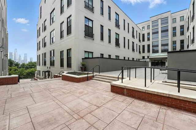 a view of tall building with large trees
