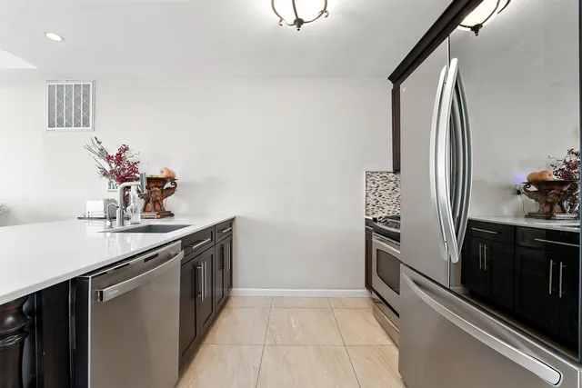 a kitchen with stainless steel appliances a sink and cabinets