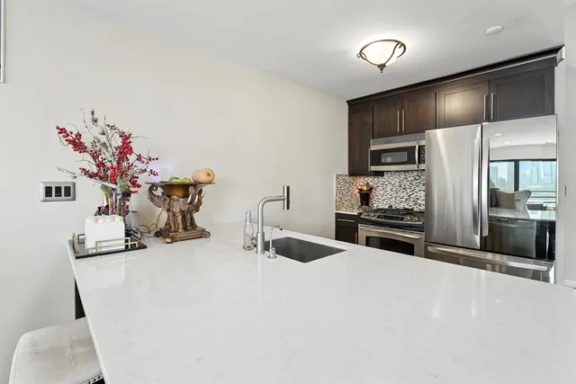a kitchen with stainless steel appliances a sink and a refrigerator