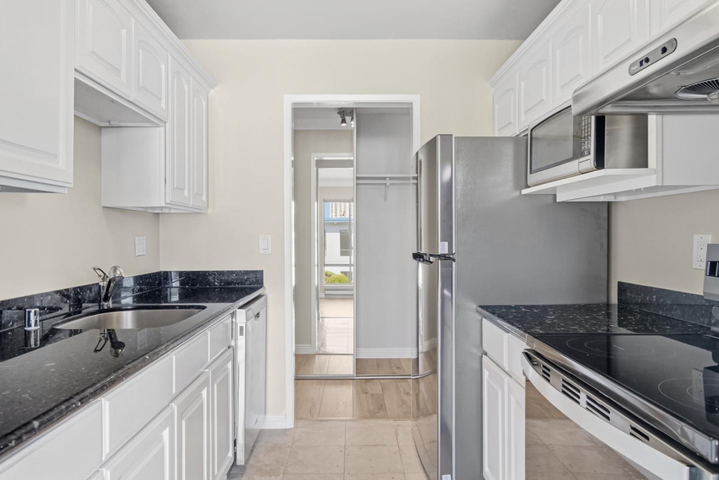 8 Commodore Drive, Unit C457 Emeryville, CA 94608 - Photo 13 of 48 a kitchen with stainless steel appliances granite countertop a sink stove and refrigerator
