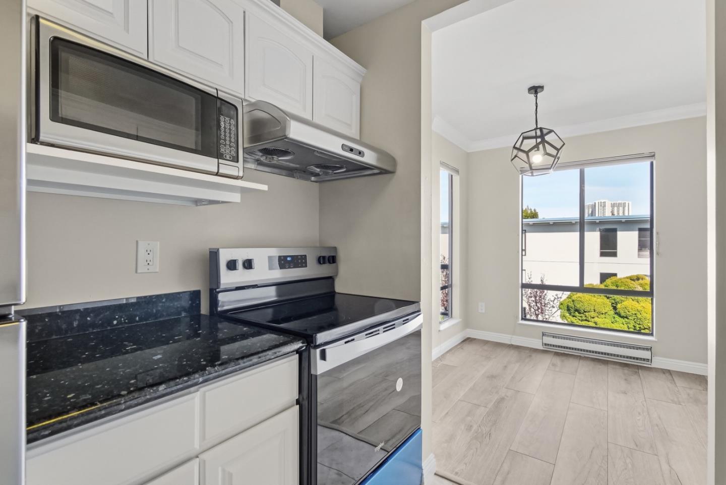 8 Commodore Drive, Unit C457 Emeryville, CA 94608 - Photo 15 of 48 a kitchen with stainless steel appliances granite countertop a stove and a microwave