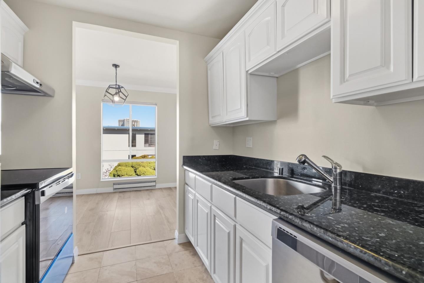 8 Commodore Drive, Unit C457 Emeryville, CA 94608 - Photo 16 of 48 a kitchen with stainless steel appliances granite countertop a sink and a stove