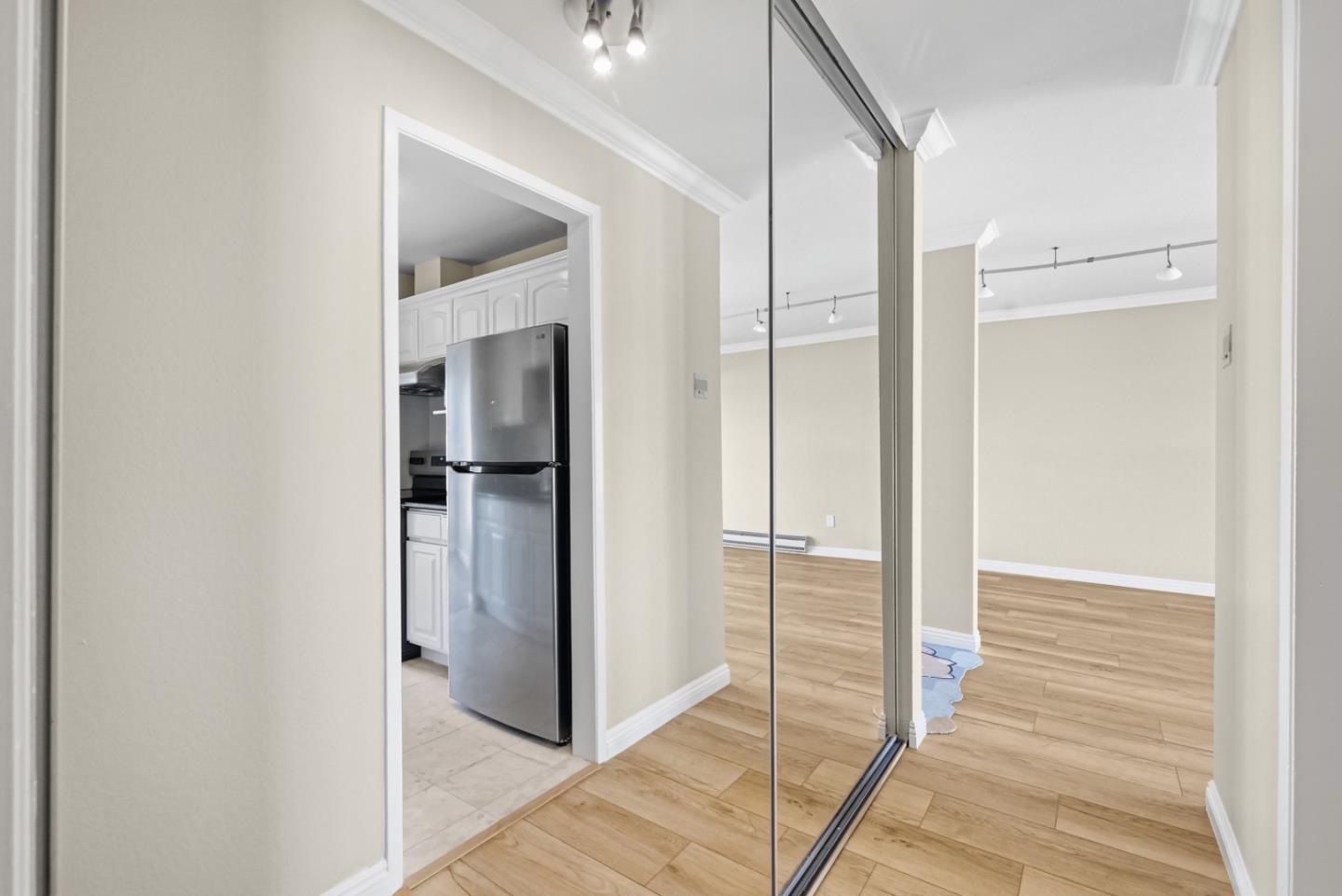 8 Commodore Drive, Unit C457 Emeryville, CA 94608 - Photo 17 of 48 a view of a hallway with wooden floor and closet