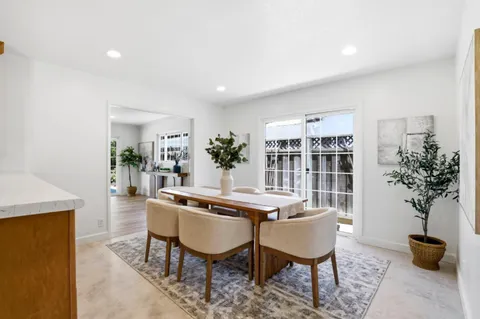 a view of a dining room with furniture and window