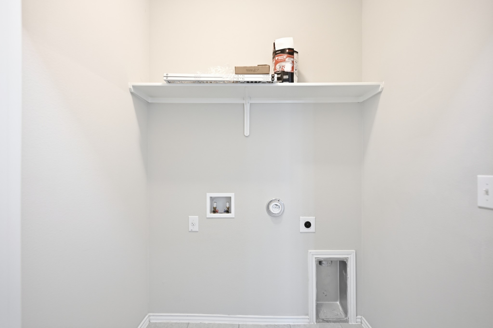 1733 Davidson Ranch Road Georgetown, TX 78626 - Photo 25 of 33 Convenient utility space features durable tile flooring and a sturdy built-in overhead shelf.
