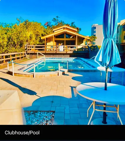 a view of a swimming pool with a chair and tables