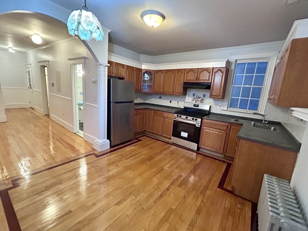 a kitchen with stainless steel appliances granite countertop a sink dishwasher stove and refrigerator