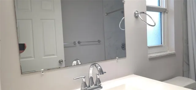 a bathroom with a sink and a mirror