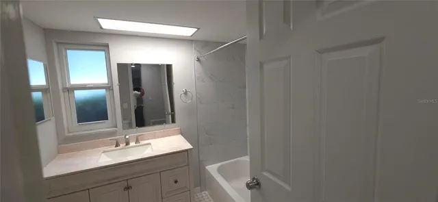a bathroom with a sink and a mirror