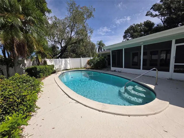 a view of a house with swimming pool and porch