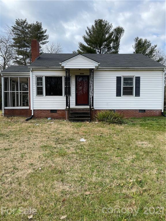 a view of a house with a large window and a yard