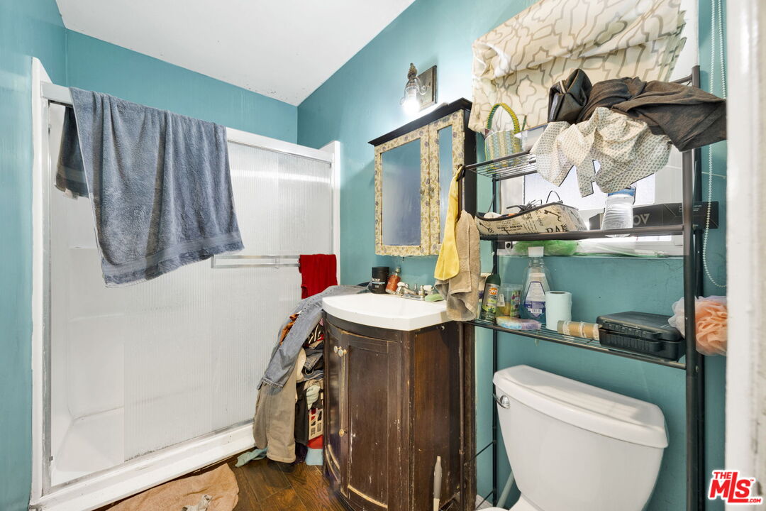 14541 Hart Street Van Nuys, CA 91405 - Photo 18 of 39 a bathroom with a sink a toilet and a mirror
