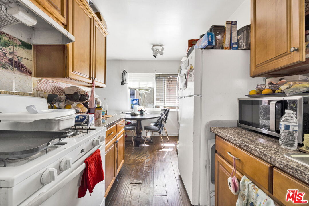 14541 Hart Street Van Nuys, CA 91405 - Photo 21 of 39 a kitchen with stainless steel appliances granite countertop a stove a sink and a refrigerator