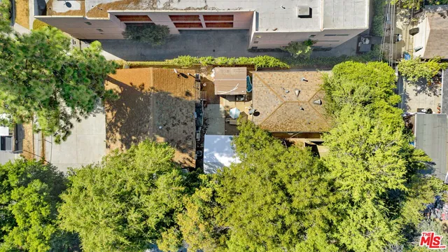 an aerial view of a house with a yard swimming pool