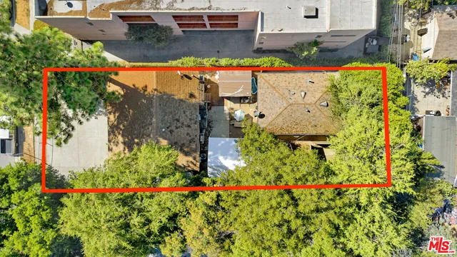 an aerial view of a house with a yard and garden