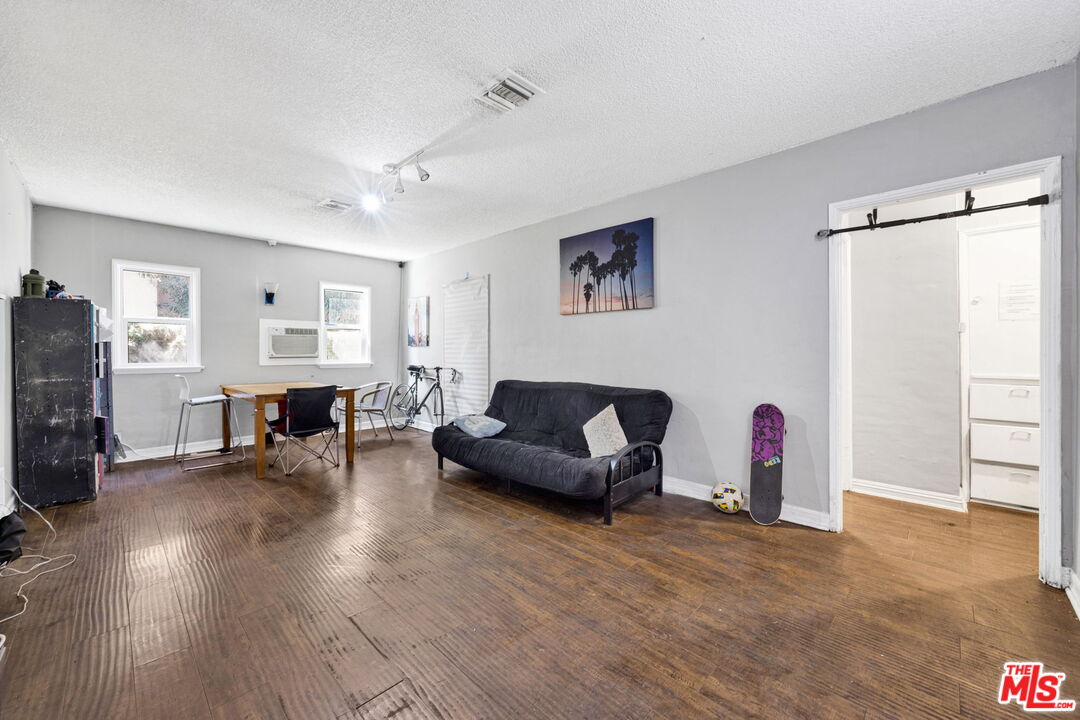 14541 Hart Street Van Nuys, CA 91405 - Photo 5 of 39 a living room with furniture and a wooden floor