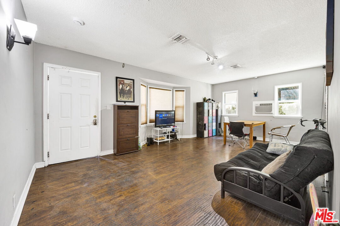 14541 Hart Street Van Nuys, CA 91405 - Photo 7 of 39 a living room with furniture and a table
