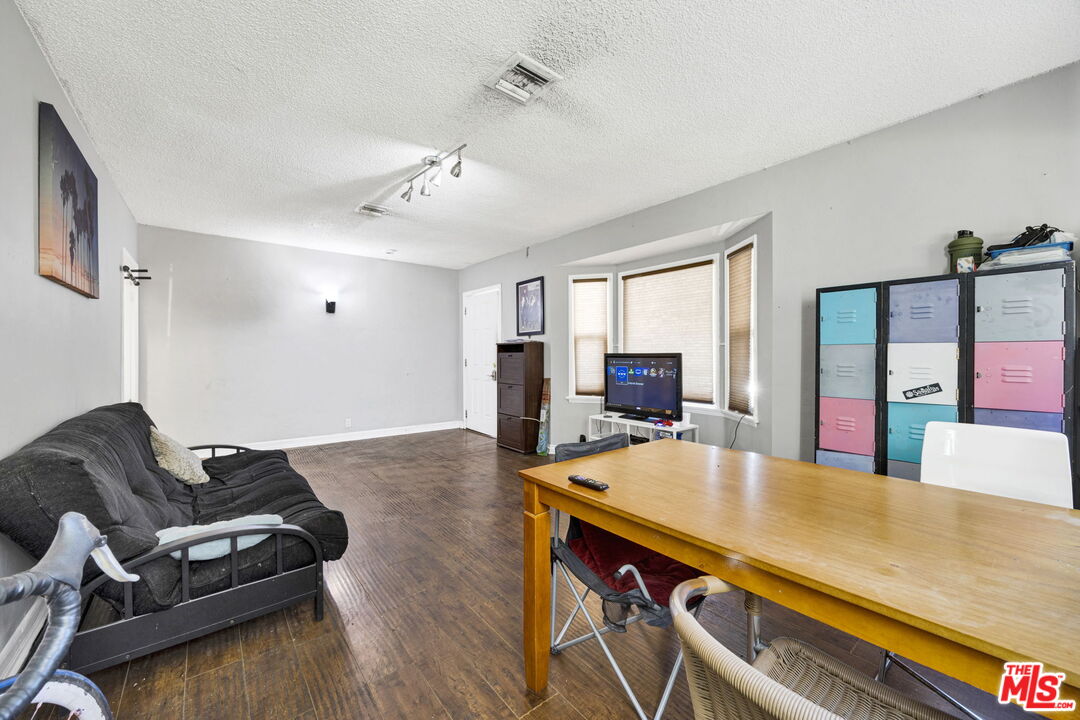 14541 Hart Street Van Nuys, CA 91405 - Photo 8 of 39 a room with furniture and a wooden floor