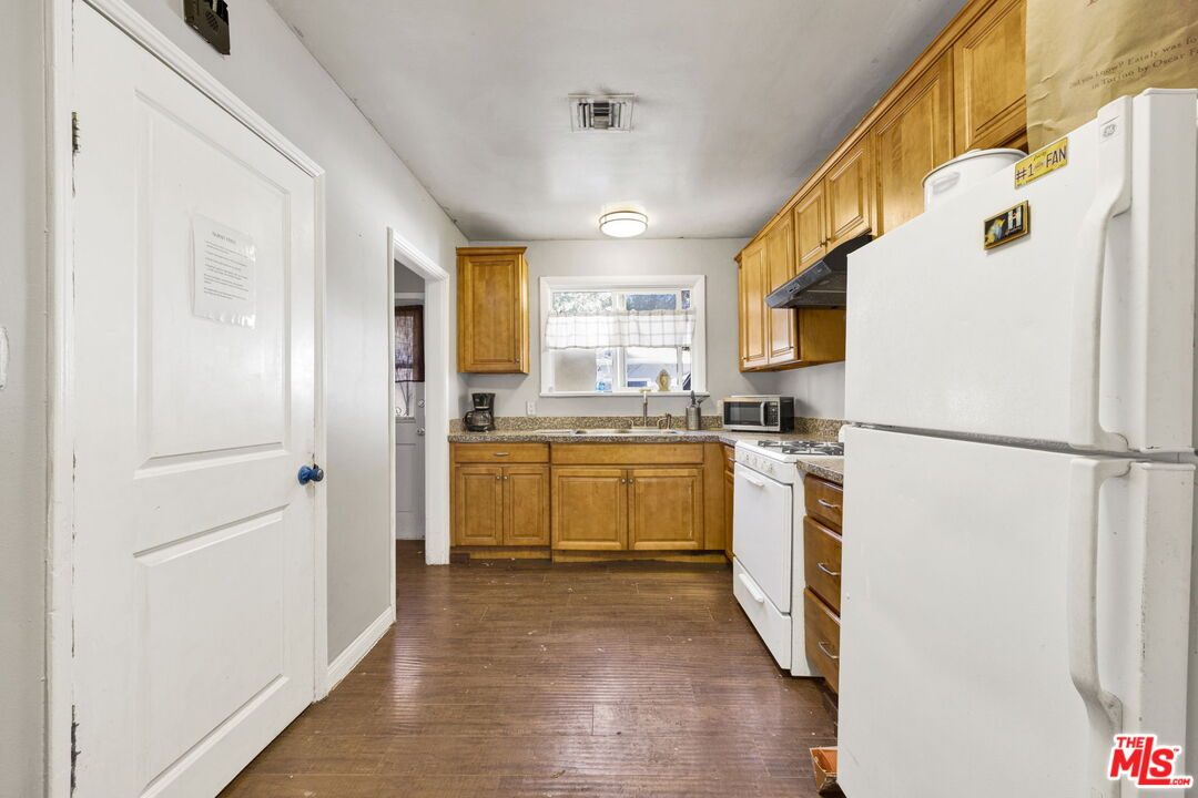 14541 Hart Street Van Nuys, CA 91405 - Photo 9 of 39 a kitchen with a refrigerator a sink and dishwasher