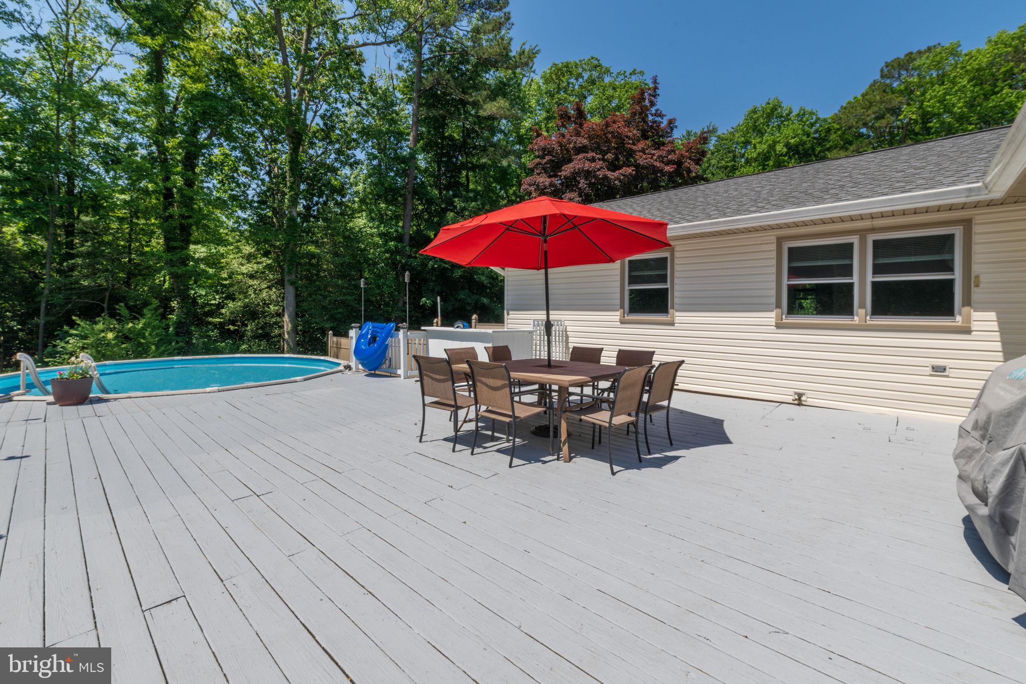 4563 Nutters Cross Road Salisbury, MD 21804 - Photo 10 of 52 an outdoor space with furniture and umbrella