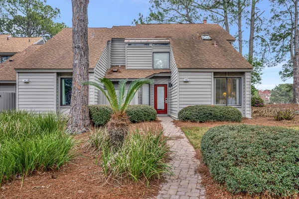 a view of a house with a yard and plants